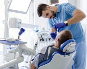 Patient Undergoing Tooth Extraction in Dental Office