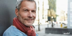 Mature Man Smiling Slightly to Hide Teeth