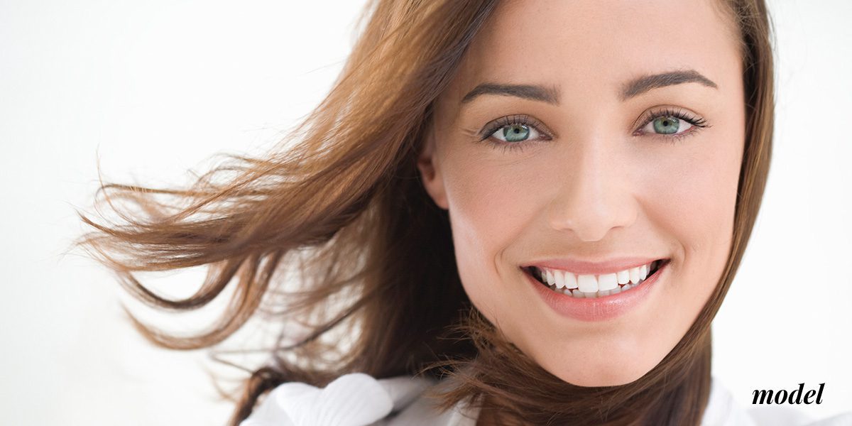 Smiling Brunette Woman Model for Widsom Teeth Rmoval
